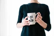 person holding mug with the words "like a boss" written on it