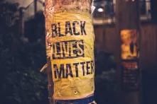 Poster mit Aufschrift "Black Lives Matter" an Straßenmast